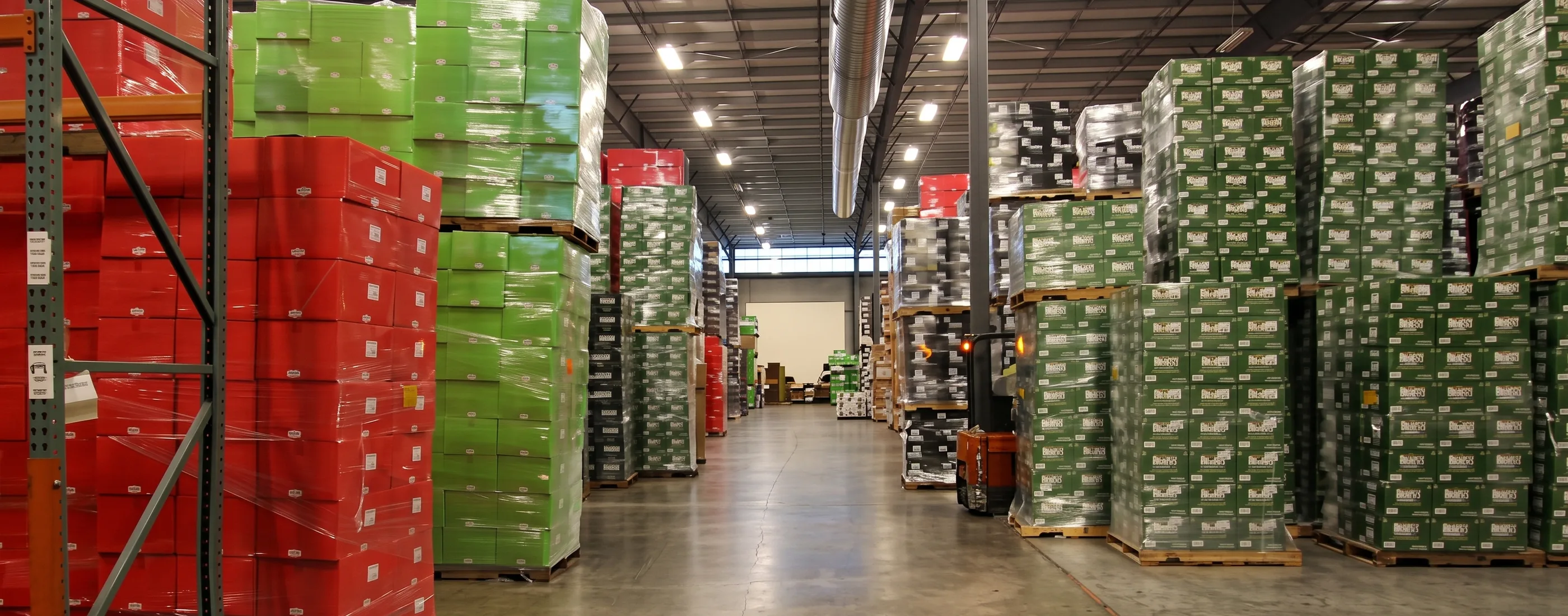 Warehouse interior at Dishaka with loaded pallet racking under high-bay lighting