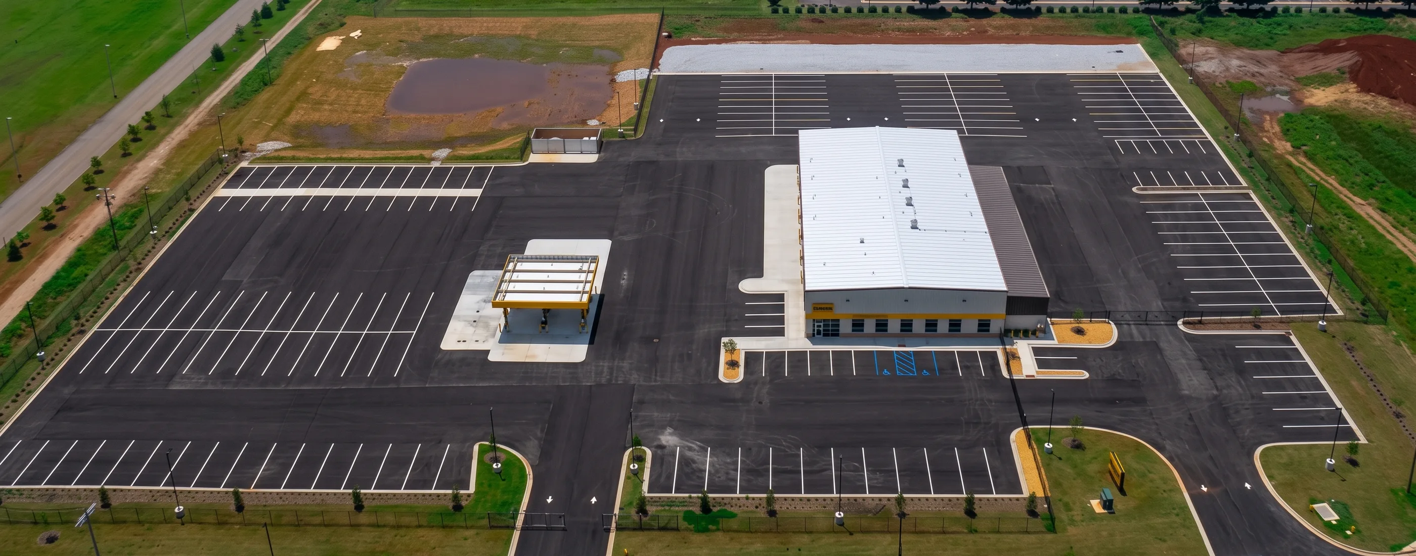 Aerial view of the Penske Dallas regional facility with its fuel island canopy, service building, and paved truck yard