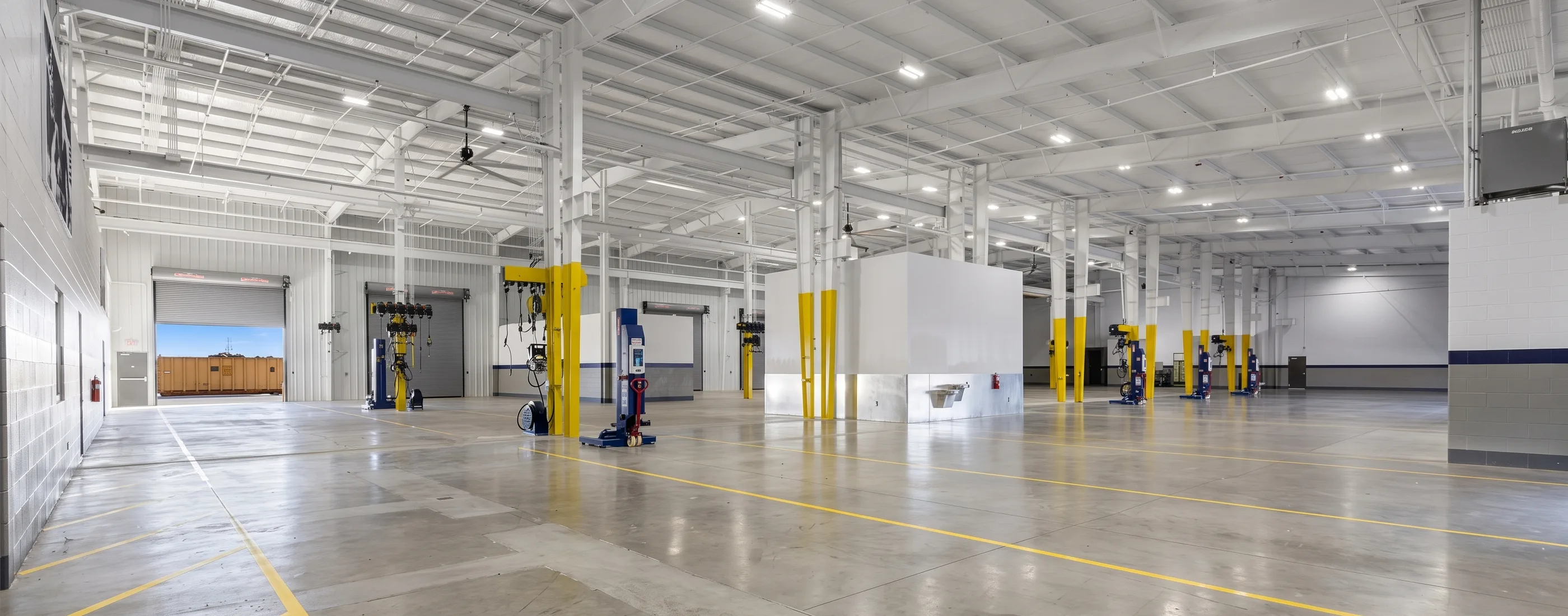 Service shop interior at the Penske Katy Service Center with lifts, columns, and drive-through bays