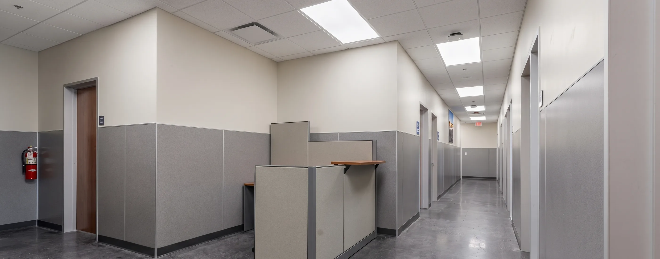 Office corridor with workstations and polished concrete floor